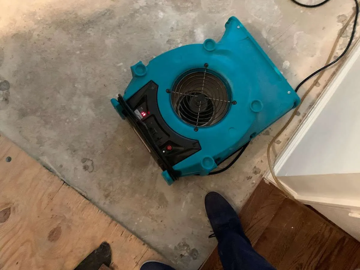 Air mover drying subfloor during Commercial Water Damage Restoration in West Des Moines